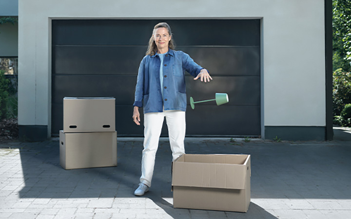 Flyttande kvinna framför garageport