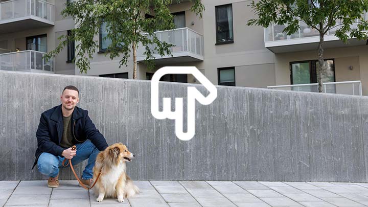 Man med hund utanför bostadshus