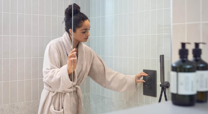 Woman in bathrobe in bathroom
