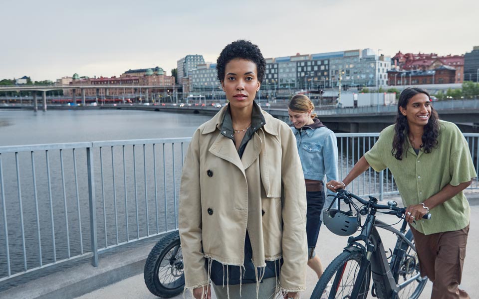 Tre personer med elcyklar på en bro