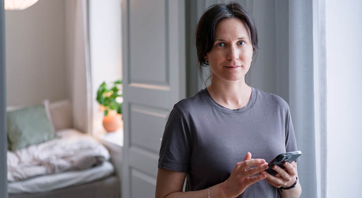 Women holding phone at home